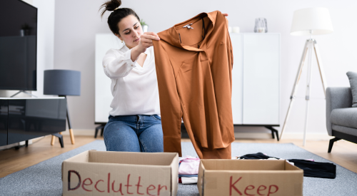 Image of woman sorting clothing into a 
