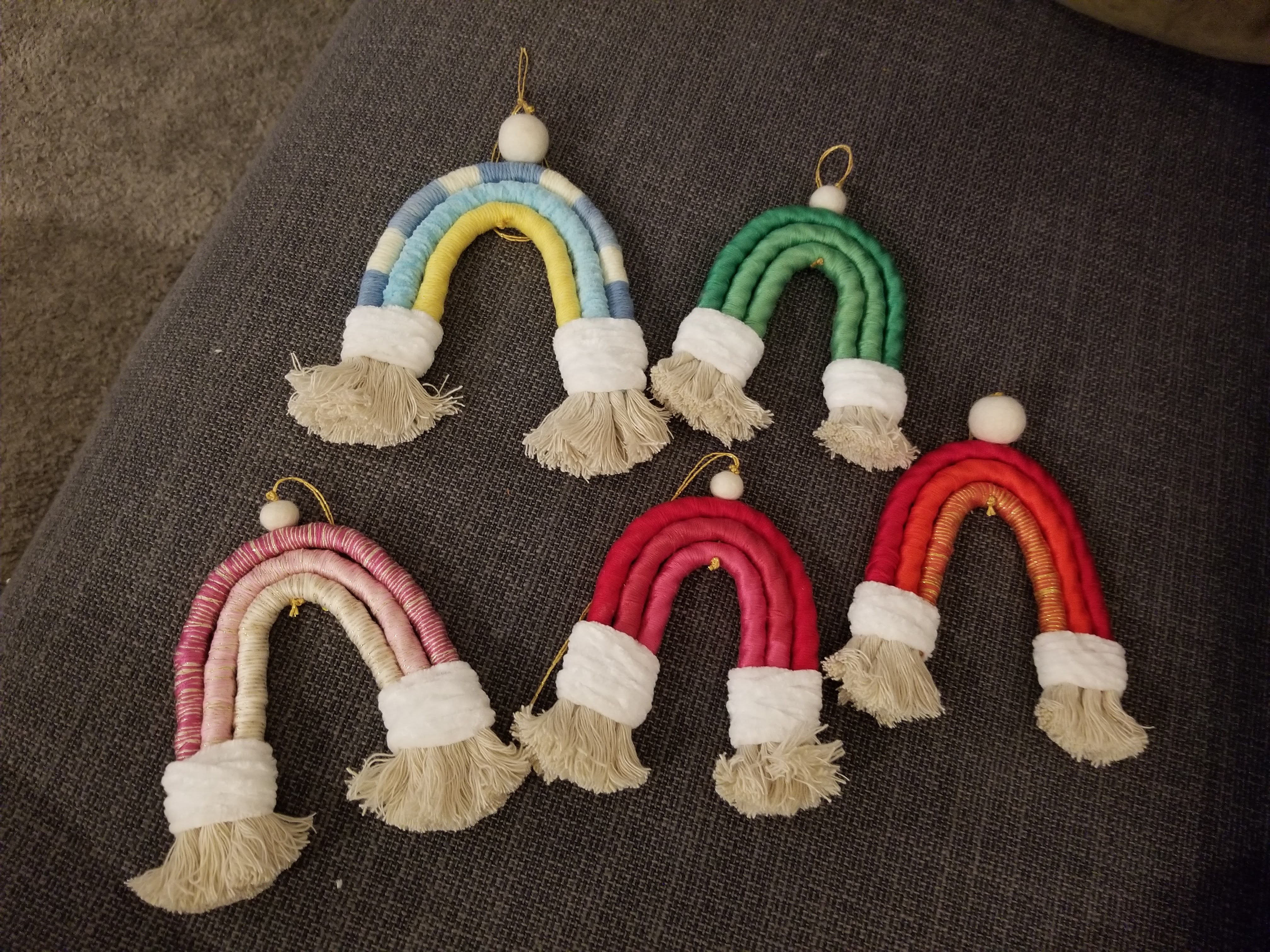 Photo of five macramé rainbows of various colors