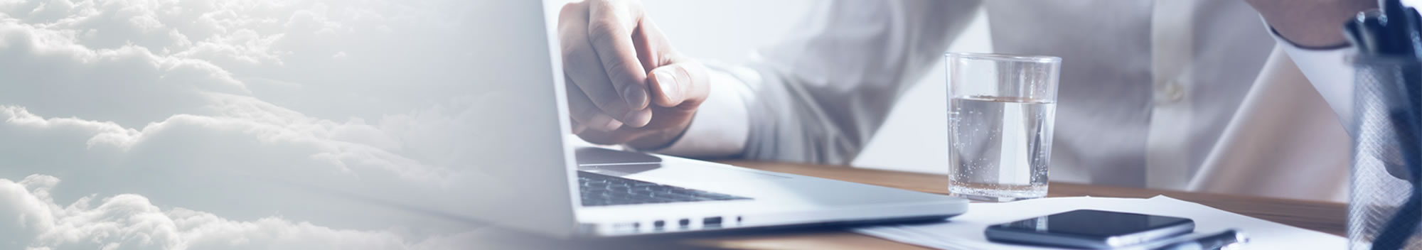 person with laptop and glass of water